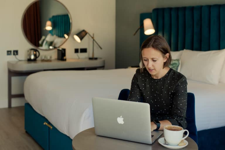Lady working on laptop in Superior bedroom